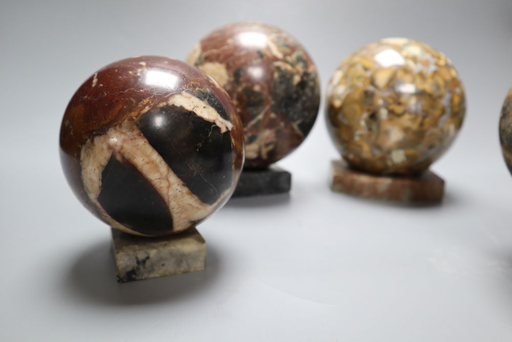 Four marble balls on stands